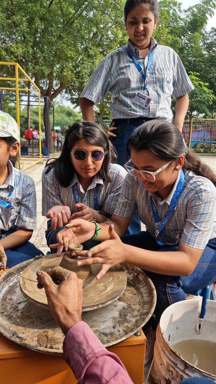 Student focused on pottery wheel activity