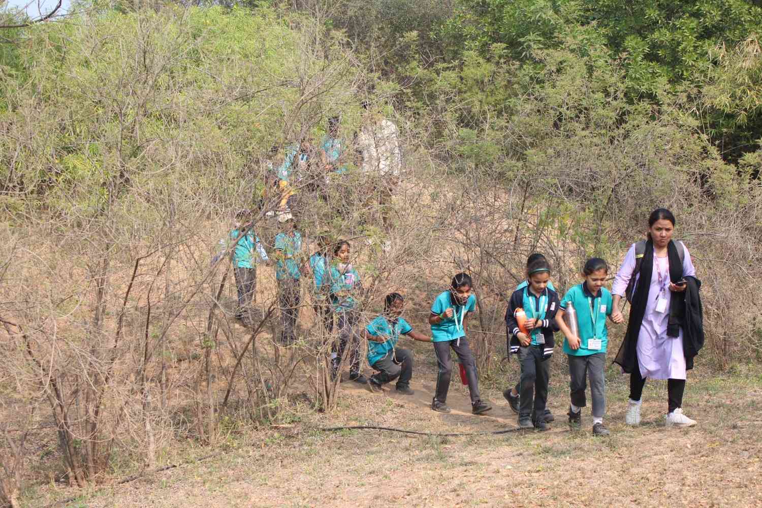School children exploring nature trails on an educational forest hike