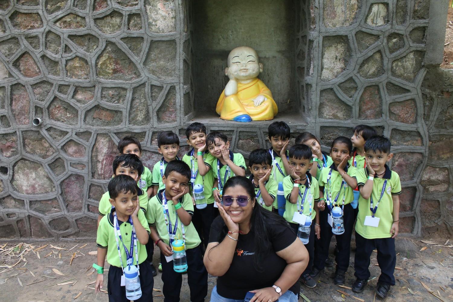 Students with resting Buddha statue at campsite