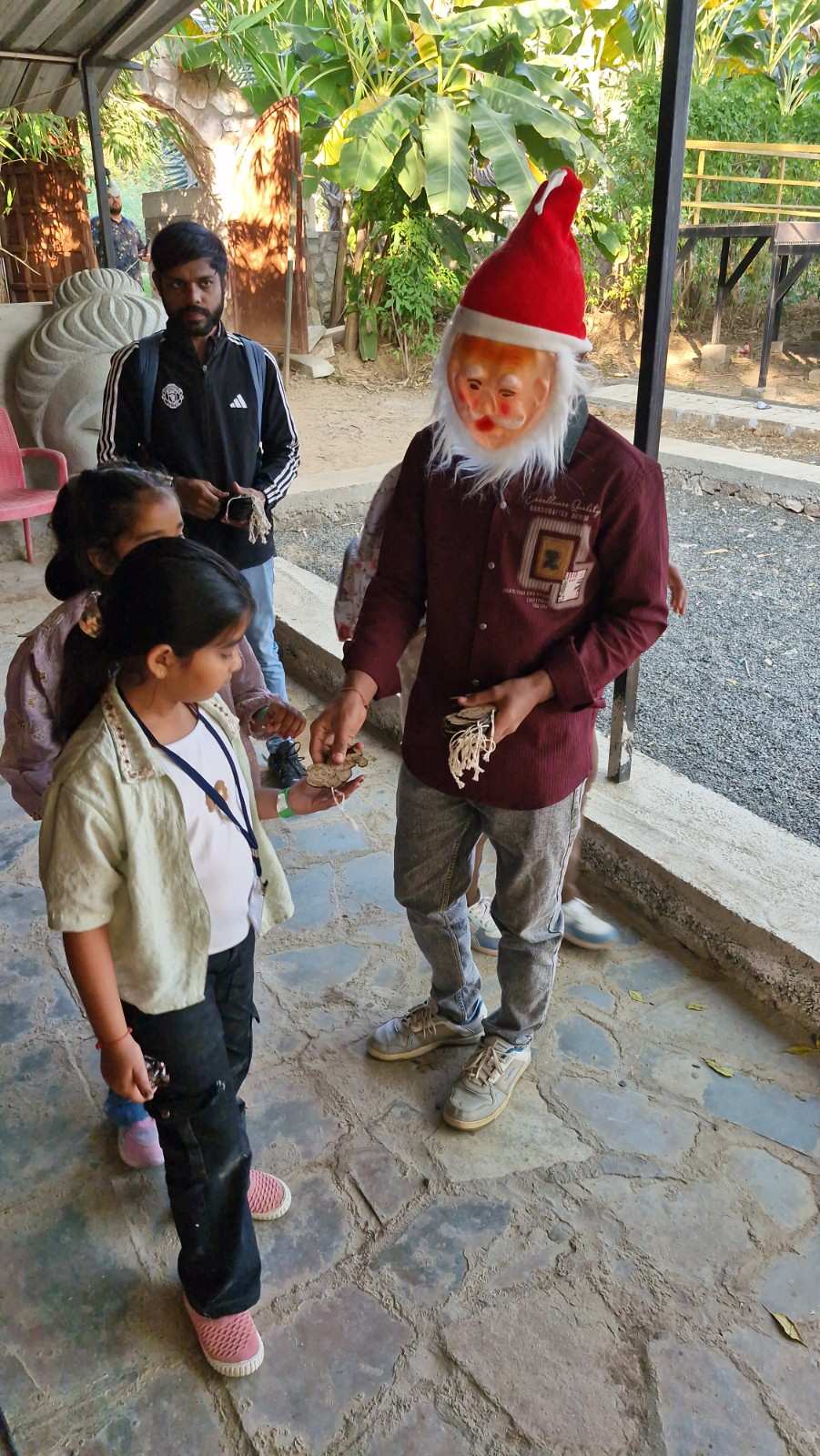 Santa Claus figure distributing gifts to school children