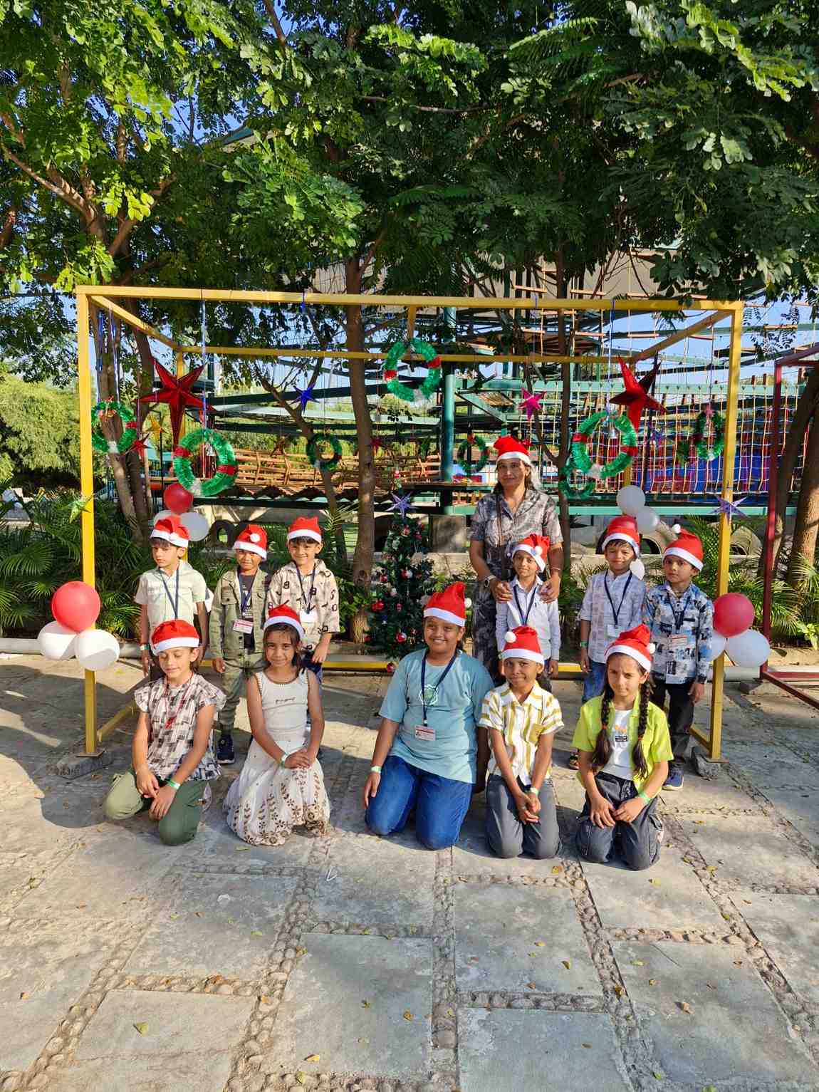 Class students wearing Santa hats for a holiday group portrait