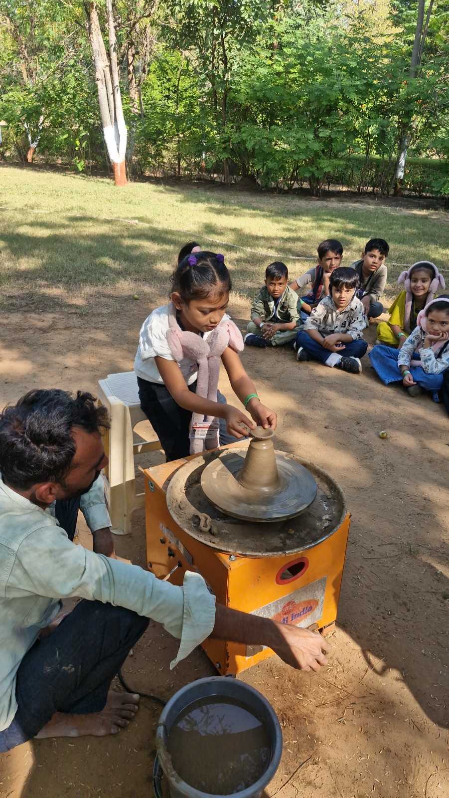 Students creating clay art during school craft day at camp