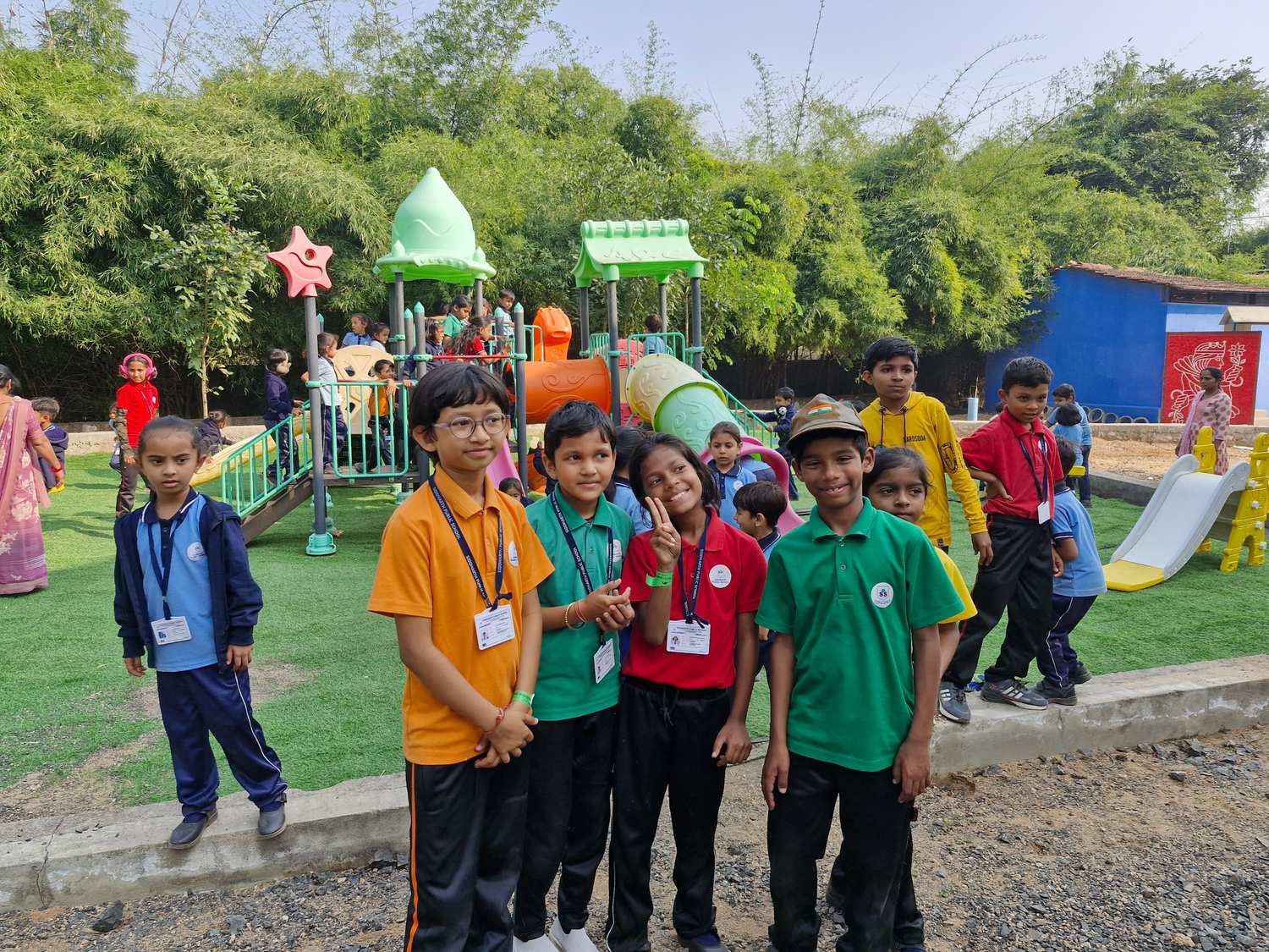 Students in house colors posing at playground