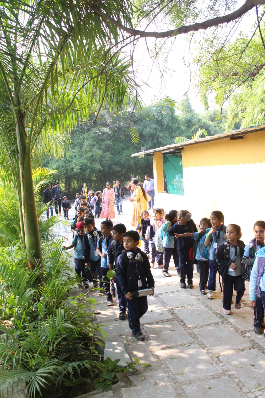 Students walking on paved nature path at resort