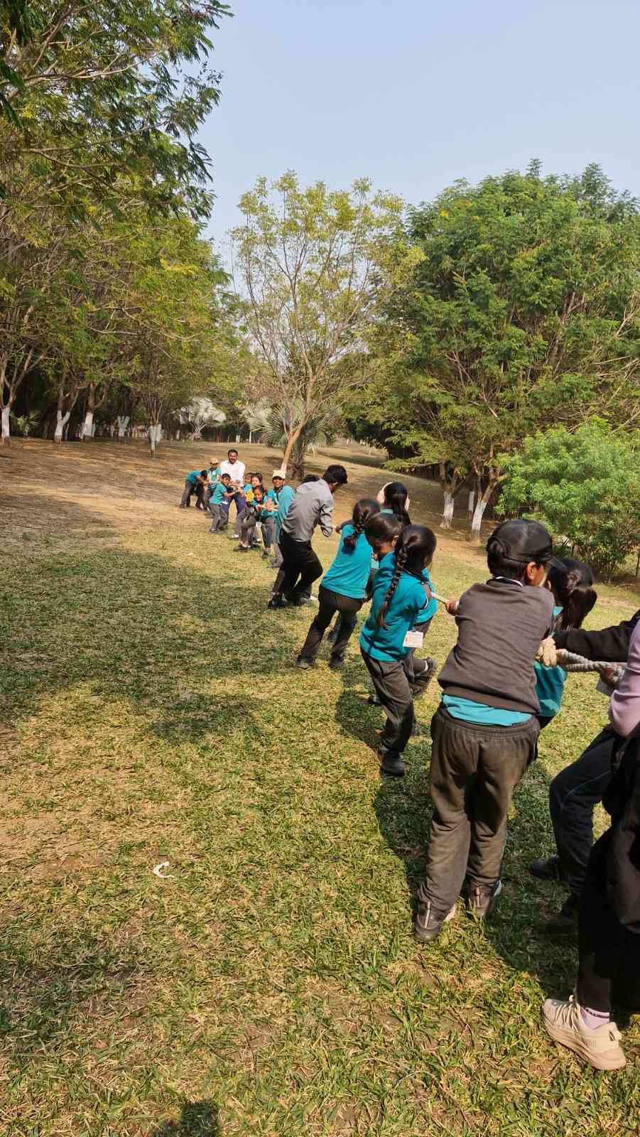 Students participating in tug of war outdoor team building activity