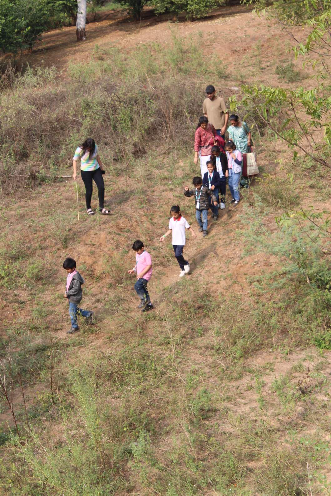 Group carefully trekking down a hill slope