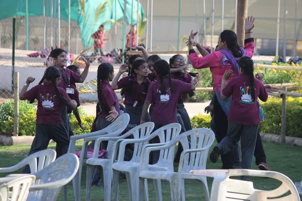 Girls enjoying dance and music activities outdoors