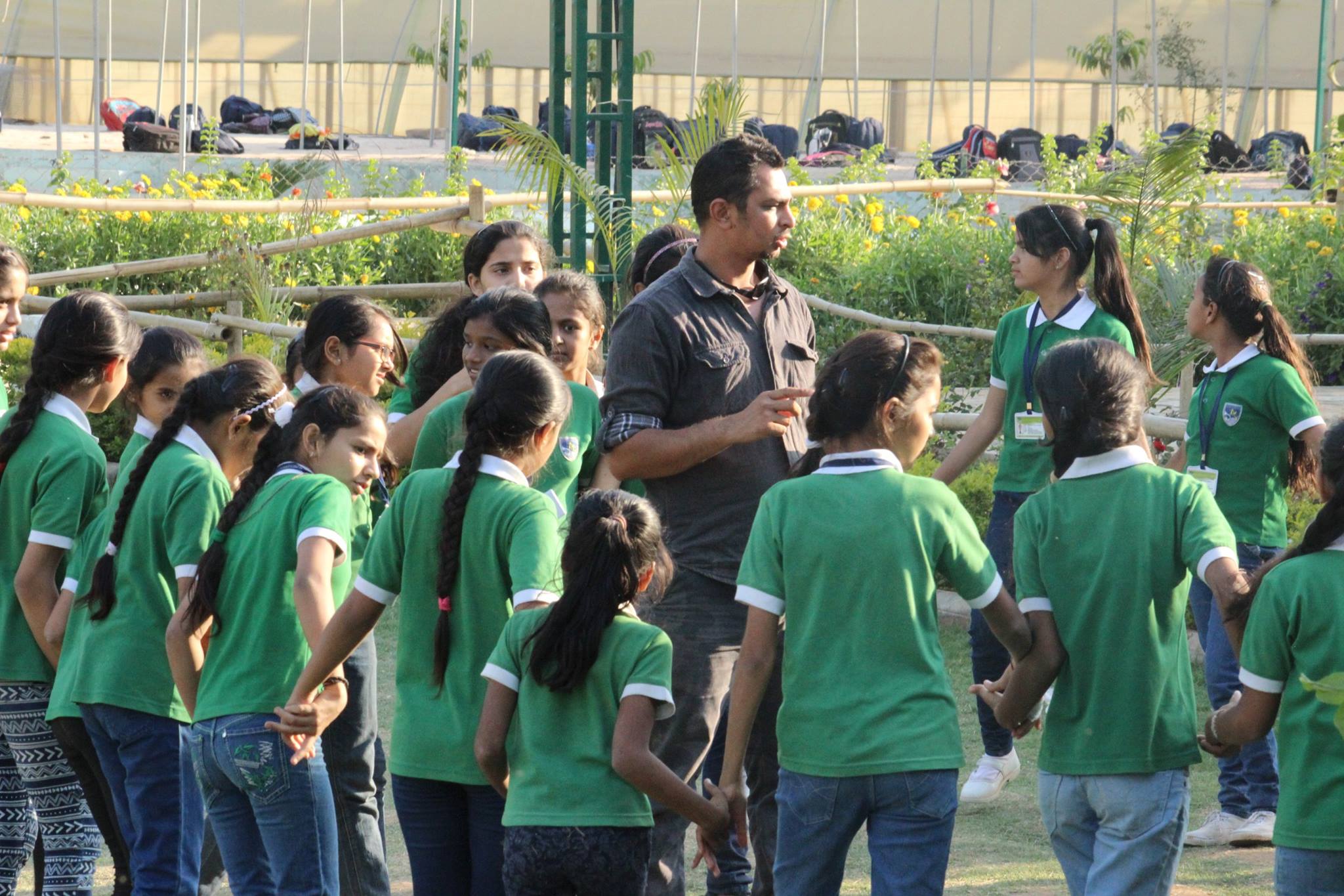 Instructor guiding group of students in green uniforms