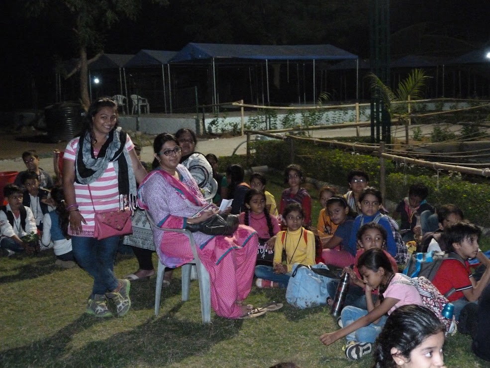 Students relaxing on the grass during evening time