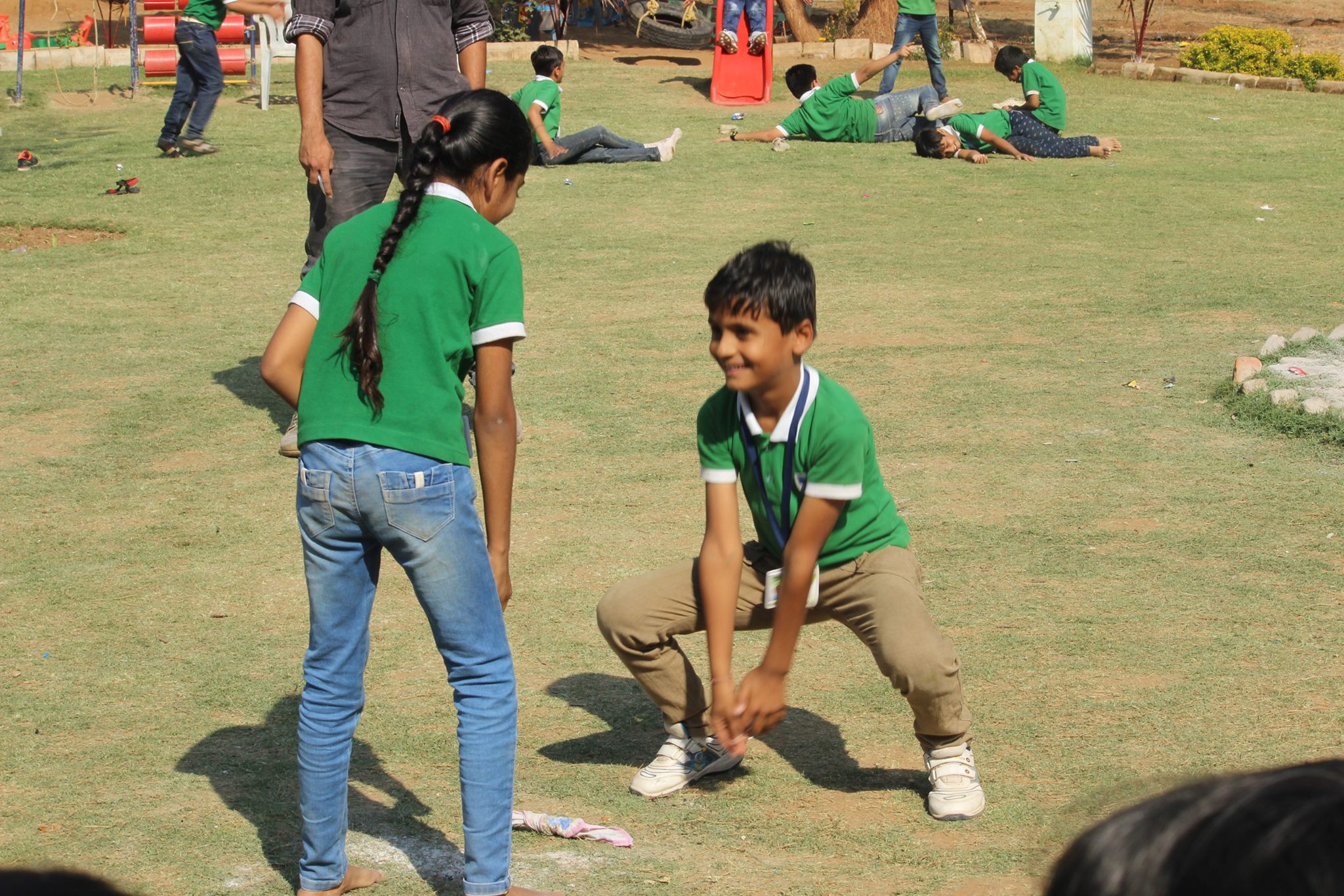 Student playing frog jump game on the grass