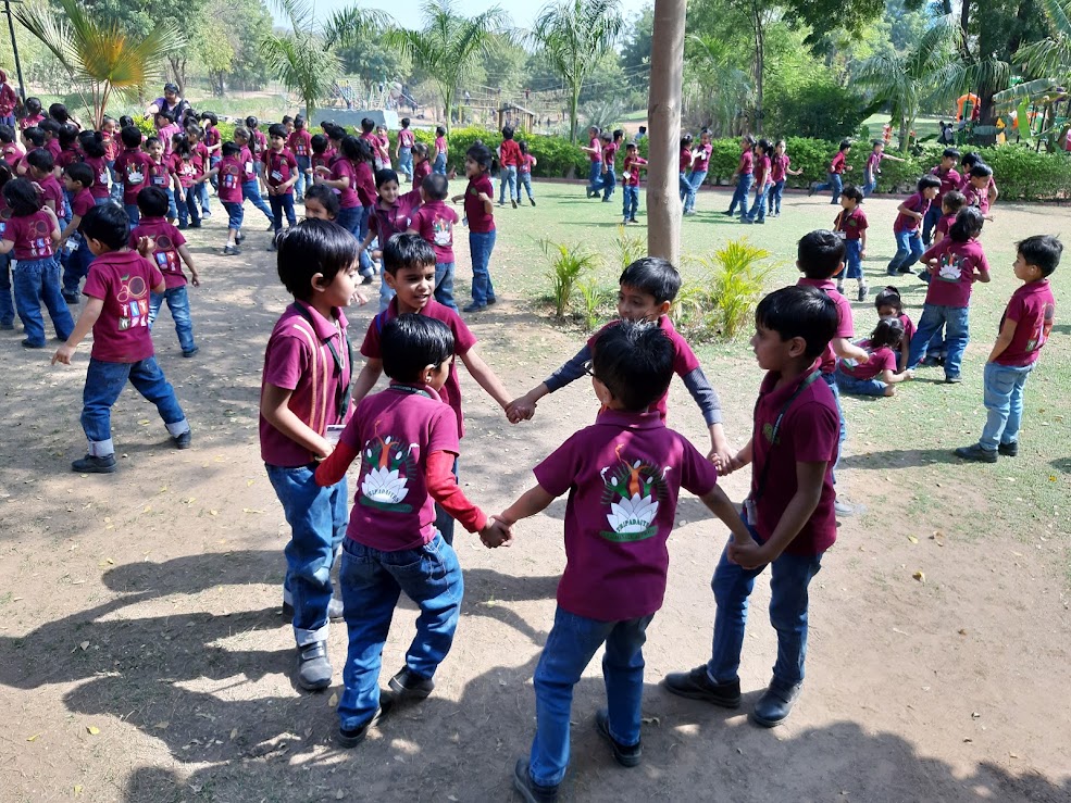 Students playing ring-a-ring-o-roses circle game