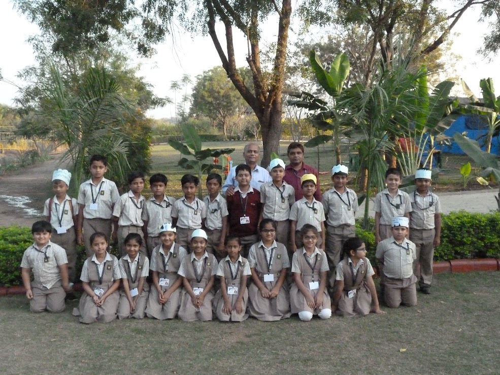 Students wearing paper chef hats for activity