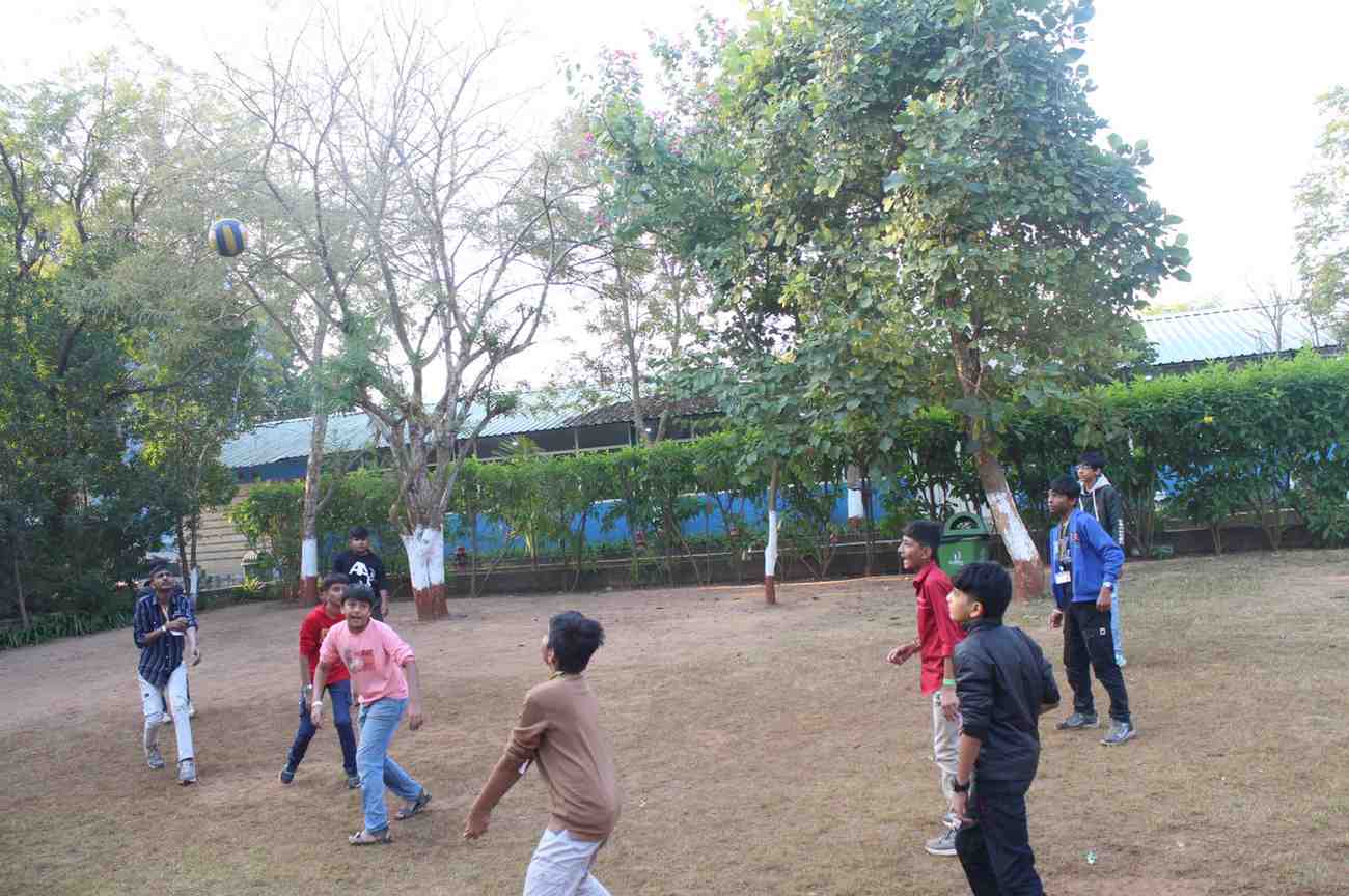 Children playing volleyball outdoors