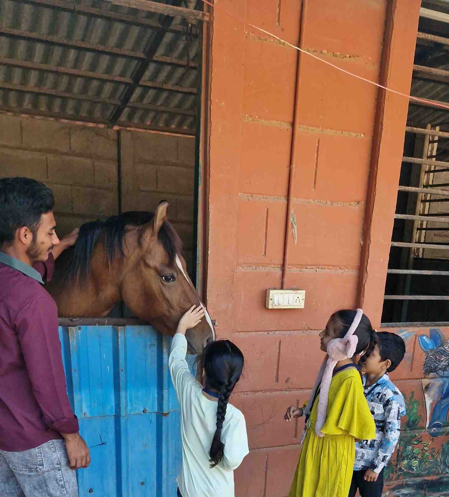 Children petting a horse