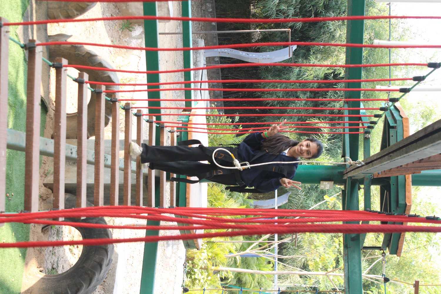 Girl smiling on high ropes