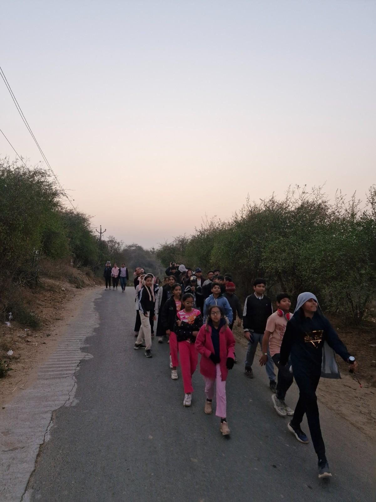 Students walking on road during hike