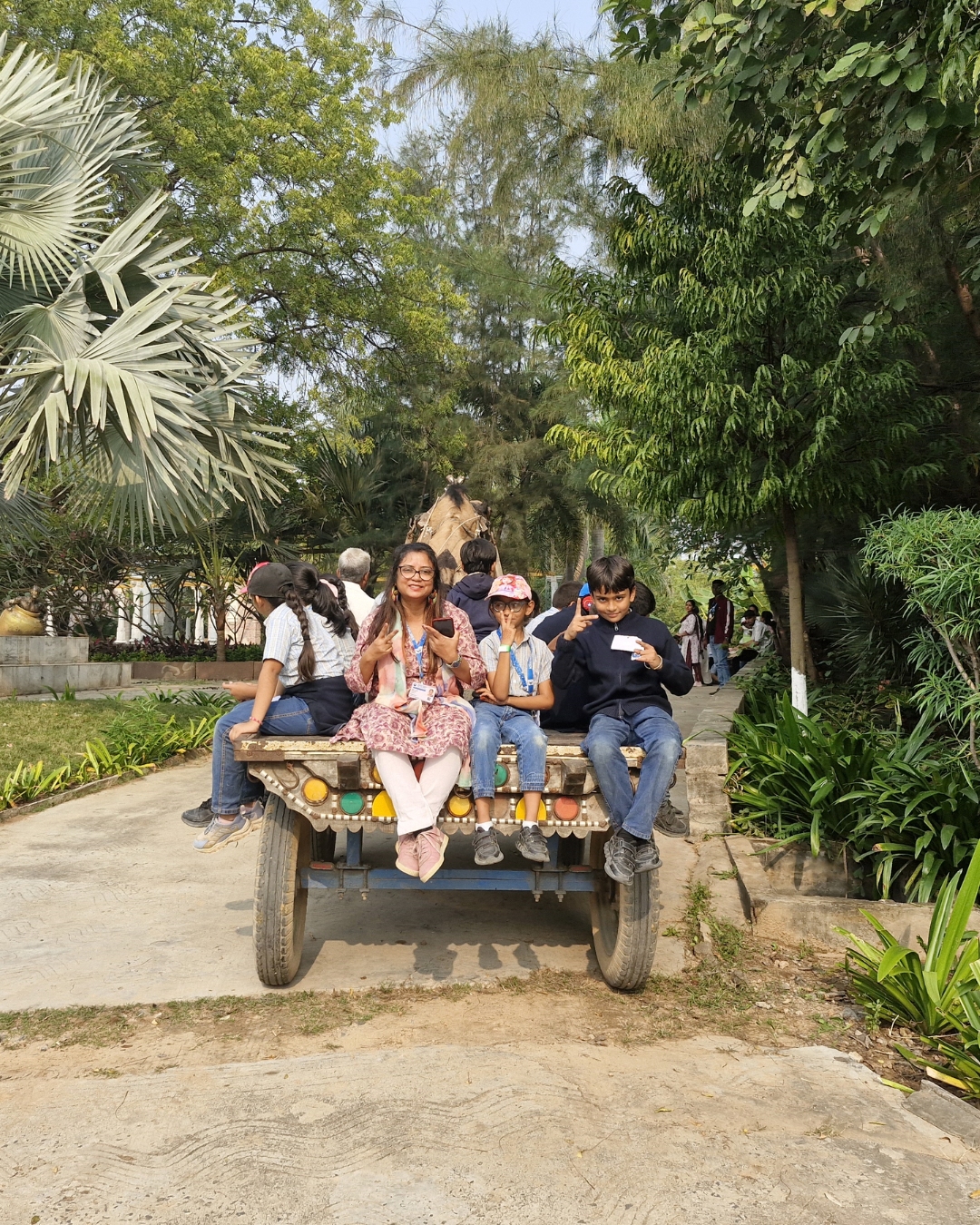 Group enjoying a camel cart ride excursion at campsite
