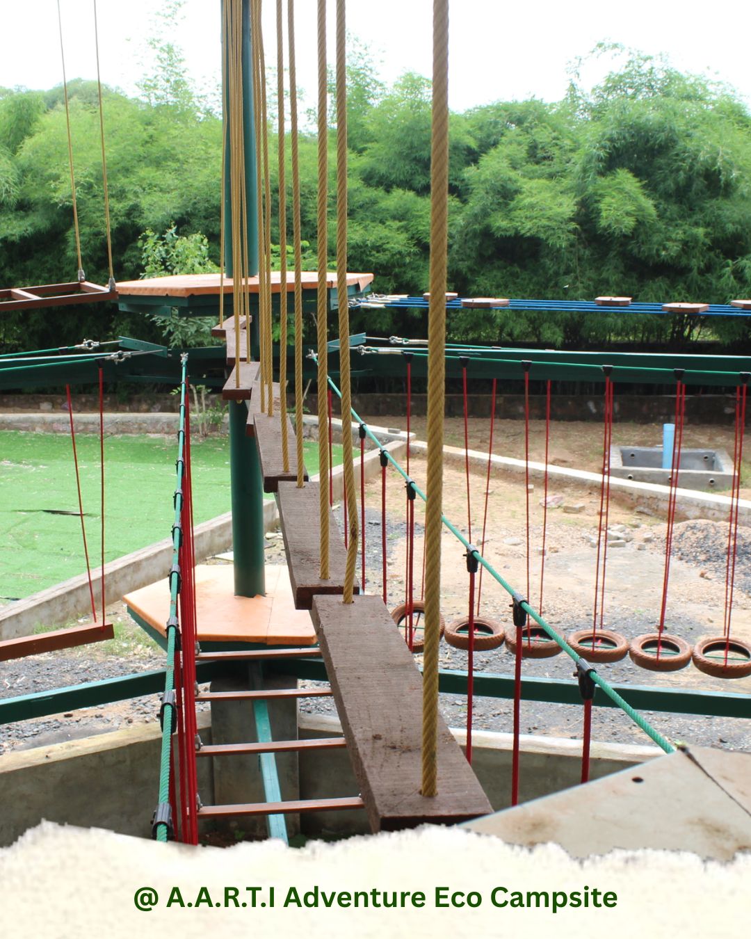 High rope adventure course with hanging wooden planks