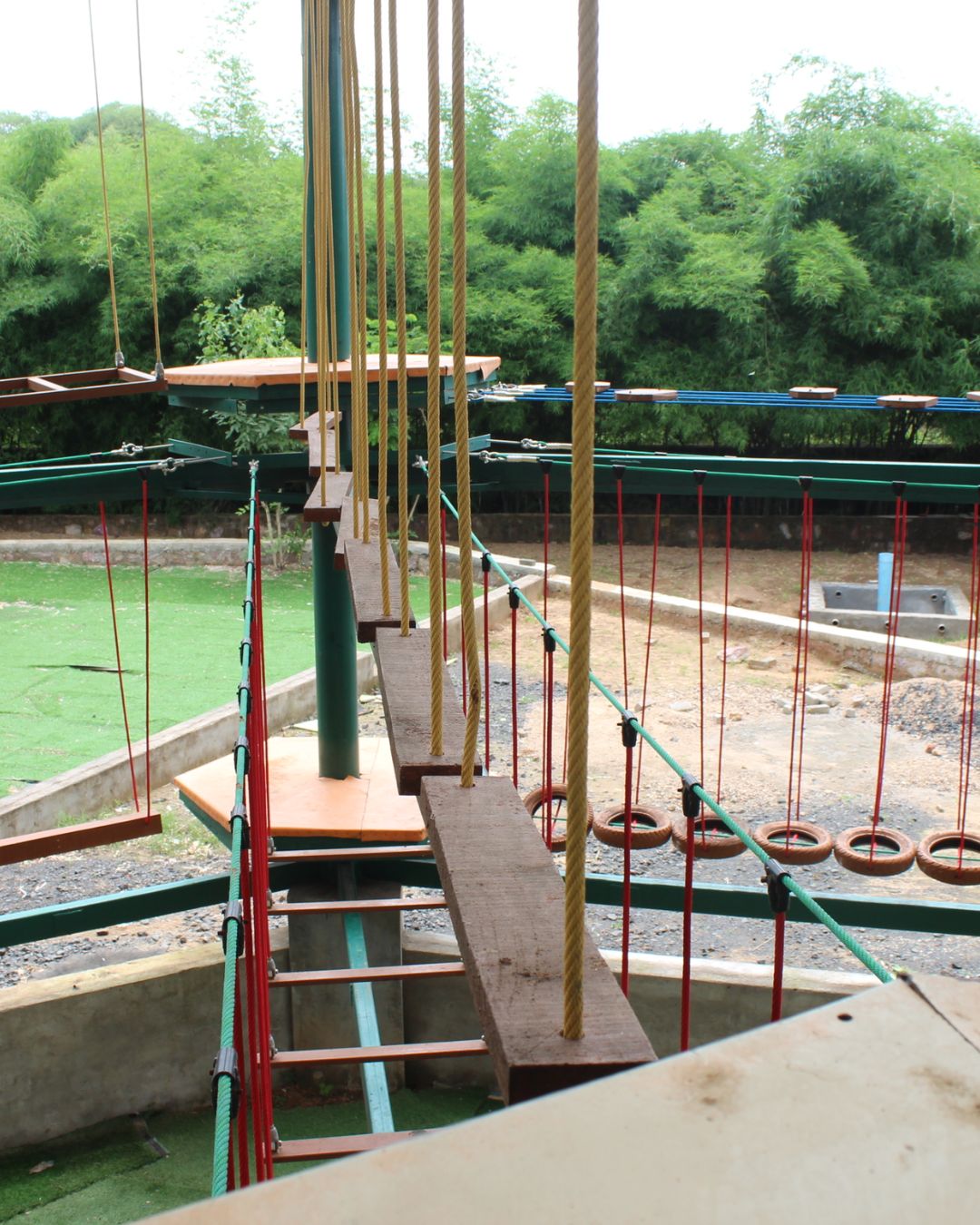 Swinging wooden plank bridge high rope obstacle