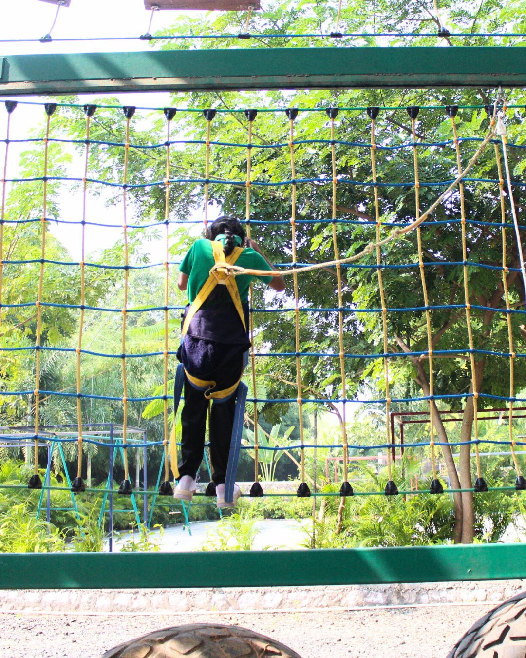 Participant climbing a vertical commando cargo net