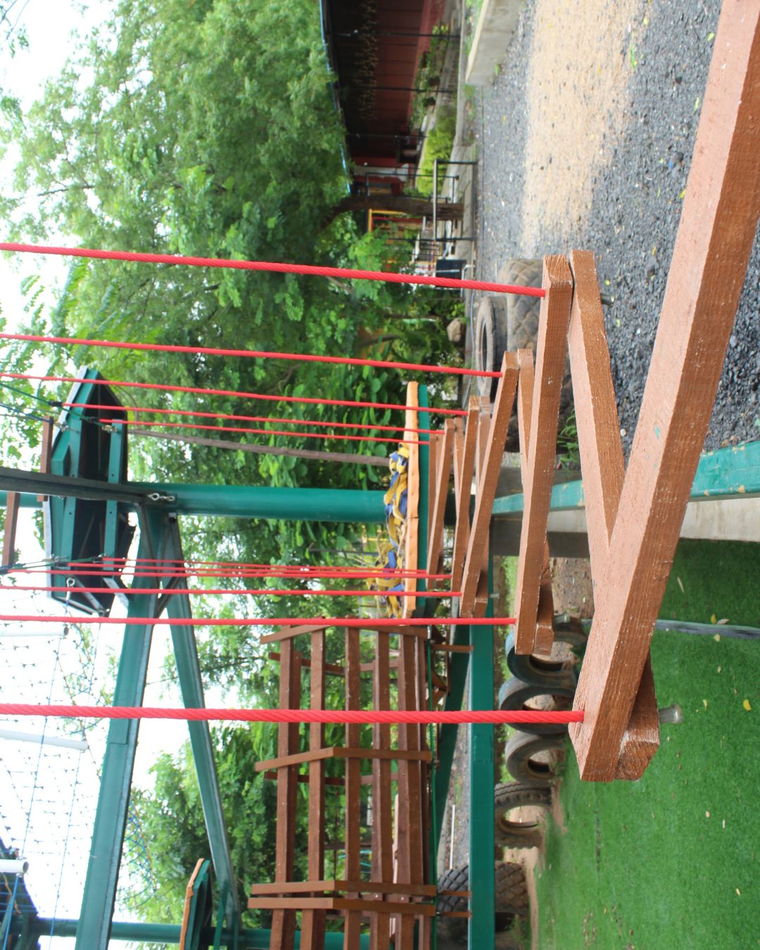 Zig-zag wooden balance beam suspended on ropes